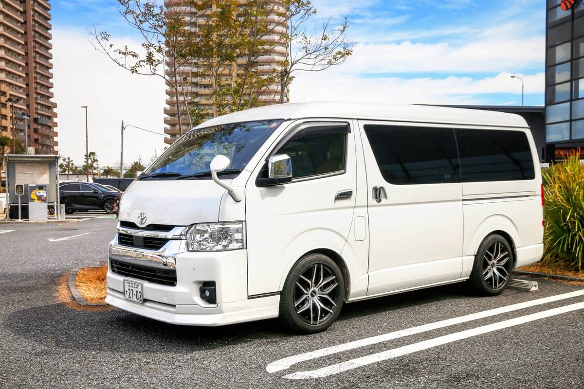 White passenger van parked in a city car park